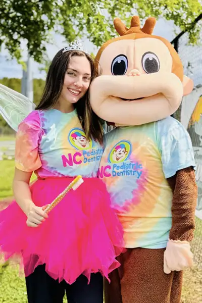 Caldwell Pediatric Dentistry's staff with a patient in a tooth fairy dress NC Pediatric Dentistry 