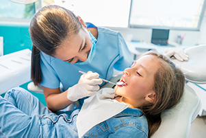 Adorable little girl getting a dental exam