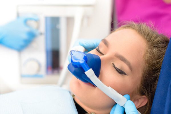 Sedated young person in a dental chair.